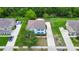 Aerial view of a two-story house with green shutters, a brown roof, and mature landscaping at 309 Black Springs Ln, Winter Garden, FL 34787