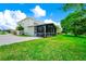 A house with a screen lanai and beautiful green backyard at 309 Black Springs Ln, Winter Garden, FL 34787