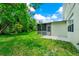 Lush backyard featuring a screened-in lanai with beautiful green grass and mature landscaping at 309 Black Springs Ln, Winter Garden, FL 34787