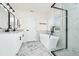 A luxurious bathroom featuring a soaking tub, marble floors, and modern black fixtures at 309 Black Springs Ln, Winter Garden, FL 34787