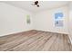 Light and airy bedroom with wood-look floors and two windows at 309 Black Springs Ln, Winter Garden, FL 34787