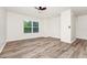 Light and airy bedroom with wood-look floors, ceiling fan, and a large window at 309 Black Springs Ln, Winter Garden, FL 34787