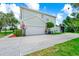 A well-maintained two-story home with an attached garage and lush landscaping at 309 Black Springs Ln, Winter Garden, FL 34787