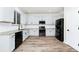 Bright kitchen featuring white cabinets, granite countertops, stainless steel appliances, and wood-look flooring at 309 Black Springs Ln, Winter Garden, FL 34787