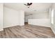 Open landing area with neutral walls, wood-look floors, and two white doors at 309 Black Springs Ln, Winter Garden, FL 34787