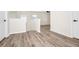 Spacious landing area with wood-look flooring and a view into other rooms at 309 Black Springs Ln, Winter Garden, FL 34787