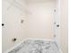 The laundry room offers functional shelving and stylish marble-look tile flooring at 309 Black Springs Ln, Winter Garden, FL 34787