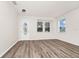 Bright living room featuring wood-look floors, neutral walls, and windows for natural light at 309 Black Springs Ln, Winter Garden, FL 34787