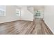 Spacious living area featuring wood-look floors and neutral walls, seamlessly connecting to other rooms at 309 Black Springs Ln, Winter Garden, FL 34787
