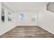 Open living room featuring wood-look floors, neutral walls, and windows for natural light at 309 Black Springs Ln, Winter Garden, FL 34787