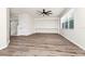 Open living room featuring wood-look floors, neutral walls, windows, and staircase to the left at 309 Black Springs Ln, Winter Garden, FL 34787