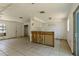 Open-concept living room with tile floors, partial kitchen view, and ample natural light at 315 Panama Cir, Winter Springs, FL 32708