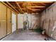Unfinished storage room featuring a water heater and access to a door at 315 Panama Cir, Winter Springs, FL 32708