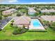 Aerial view of the community featuring a pool, clubhouse, and neatly arranged homes in a lush setting at 3309 Wilshire Way Rd # 3, Orlando, FL 32829