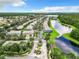 Aerial view of a beautiful neighborhood with lush greenery, a tranquil lake, and well-maintained streets at 3309 Wilshire Way Rd # 3, Orlando, FL 32829