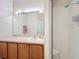 Bathroom boasts a vanity with a large mirror, light fixtures, and a walk-in shower with a seat at 3309 Wilshire Way Rd # 3, Orlando, FL 32829