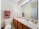 Bathroom features a vanity with wooden cabinets and a large mirror with light fixtures at 3309 Wilshire Way Rd # 3, Orlando, FL 32829