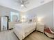 Bright bedroom with light wood floors, modern ceiling fan, and light neutral walls at 3309 Wilshire Way Rd # 3, Orlando, FL 32829