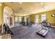 Well-equipped gym with modern exercise machines, a mirrored wall, and plenty of natural light at 3309 Wilshire Way Rd # 3, Orlando, FL 32829