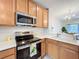 Modern kitchen with stainless steel appliances and light wood cabinetry at 3309 Wilshire Way Rd # 3, Orlando, FL 32829