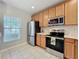 Modern kitchen featuring stainless steel appliances and tile flooring at 3309 Wilshire Way Rd # 3, Orlando, FL 32829