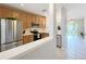 Updated kitchen featuring stainless steel appliances and open layout leading to dining area at 3309 Wilshire Way Rd # 3, Orlando, FL 32829