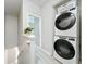 Convenient upstairs laundry area features a stacked washer and dryer at 3309 Wilshire Way Rd # 3, Orlando, FL 32829