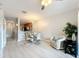 Inviting living room showcasing modern light fixtures and views to kitchen at 3309 Wilshire Way Rd # 3, Orlando, FL 32829