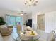 Bright living room featuring a glass dining table and view to outdoor patio at 3309 Wilshire Way Rd # 3, Orlando, FL 32829