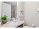 Bright bathroom features granite countertop vanity, shower, and decor at 341 Burma St, Kissimmee, FL 34747