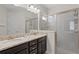 Bathroom with double sinks, granite countertops, and a glass-enclosed shower, providing a luxurious experience at 341 Burma St, Kissimmee, FL 34747