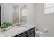 Bright bathroom features a granite countertop vanity and shower at 341 Burma St, Kissimmee, FL 34747