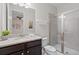 Well-lit bathroom featuring granite countertop vanity and a glass-enclosed shower at 341 Burma St, Kissimmee, FL 34747