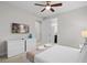 Inviting bedroom with flat-screen TV, sleek white furniture and an attached bathroom entrance at 341 Burma St, Kissimmee, FL 34747