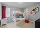 Cheerful bedroom with a bunk bed and colorful Disney themed wallpaper and decor at 341 Burma St, Kissimmee, FL 34747