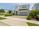 Attractive two-story home showcasing a brick driveway, gray garage door, and well-maintained landscaping at 341 Burma St, Kissimmee, FL 34747