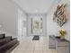 Welcoming foyer with tile flooring, modern art, and a staircase on the left at 341 Burma St, Kissimmee, FL 34747