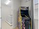 Game room complete with an arcade machine and a laundry room in the background, perfect for entertainment at 341 Burma St, Kissimmee, FL 34747