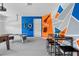 This garage features game-themed decor on the accent walls and also contains a pub table with high stools at 341 Burma St, Kissimmee, FL 34747
