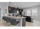 Modern kitchen with dark cabinets, granite countertops, and stainless steel appliances at 341 Burma St, Kissimmee, FL 34747