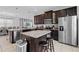 Modern kitchen featuring stainless steel appliances, granite countertops, and a convenient island with bar stool seating at 341 Burma St, Kissimmee, FL 34747