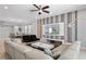 Elegant living room featuring a sectional sofa, modern TV, and stylish decor at 341 Burma St, Kissimmee, FL 34747