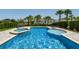 Beautiful pool and spa surrounded by lush landscaping and lounge chairs, perfect for relaxing outdoors at 341 Burma St, Kissimmee, FL 34747