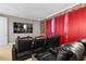 This home theater boasts tiered seating, cup holders, and a brick accent wall with red curtains at 341 Burma St, Kissimmee, FL 34747