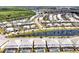 Aerial view of new homes in a community with multiple lakes and palm tree lined streets at 3860 Sonoma Blvd, Kissimmee, FL 34741