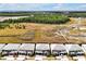 Aerial view of new construction homes adjacent to undeveloped land and a winding road at 3860 Sonoma Blvd, Kissimmee, FL 34741