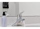 Chrome faucet with a bottle of hand soap on a white solid surface countertop in the bathroom at 3860 Sonoma Blvd, Kissimmee, FL 34741