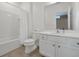 Bright bathroom featuring a shower-tub combination, toilet, and vanity with granite countertop and a large mirror at 3860 Sonoma Blvd, Kissimmee, FL 34741