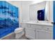 Modern bathroom with white vanity, dolphin shower curtain, and ample lighting at 3860 Sonoma Blvd, Kissimmee, FL 34741
