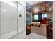 Modern bathroom with walk-in glass shower, marble-look floors and a view to the bedroom at 3860 Sonoma Blvd, Kissimmee, FL 34741